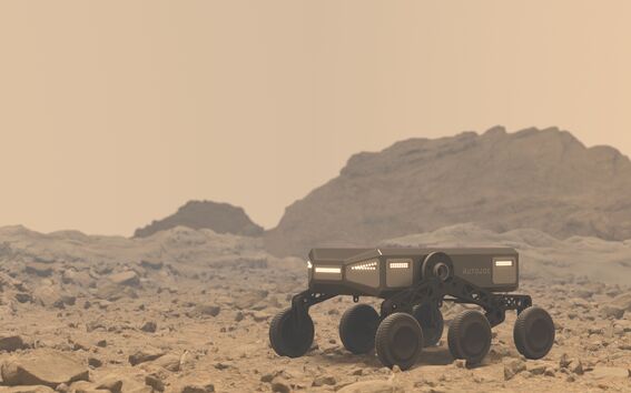 A six-wheeled autonomous vehicle on a rocky terrain with distant hills under a beige sky.
