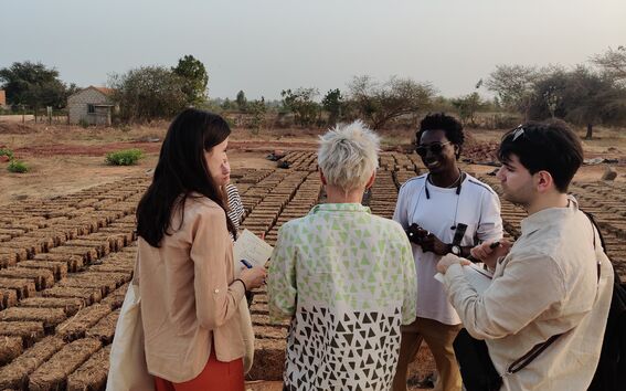 Students learning about sustainable construction techniques from Doudou Deme, founder of Elementerre, a local Senagalese construction company producing clay and typha bricks