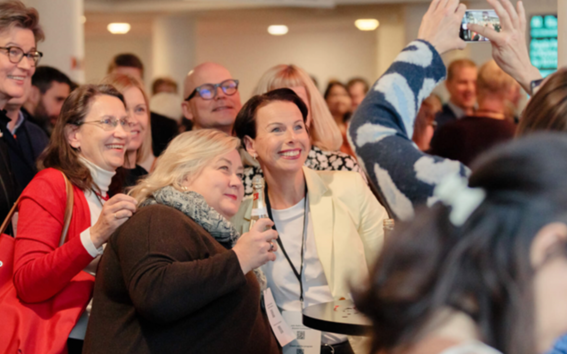 Alumni smiling and posing for the camera