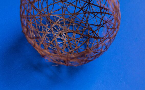 willow fibre ball on a blue surface