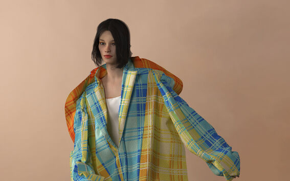 Person wearing an oversized, colourful plaid coat over a white top against a plain background.