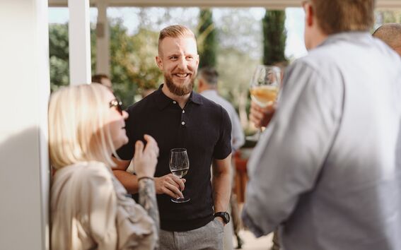 Alum Tuomas Paananen talking with colleagues
