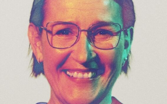 Monica Österberg has short hair and is wearing a collared shirt and a necklace with a small pendant.