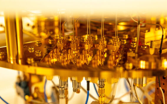 Close-up of a complex gold-coloured machine with various wires and connectors.