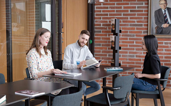 People sitting around a table having a conversation.