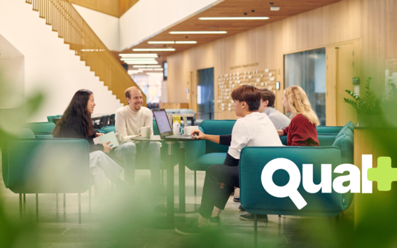 People working together in the Business School lounge. Qual+ logo added on top.