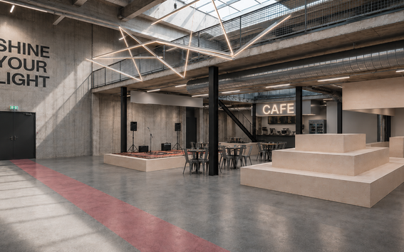 Spacious hall with a stage, tiered seating and a café
