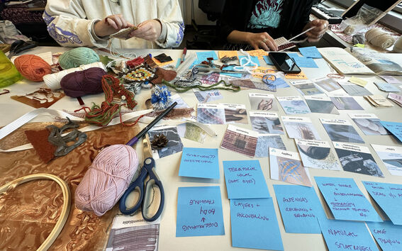 Notes, yarn and samples on a table.