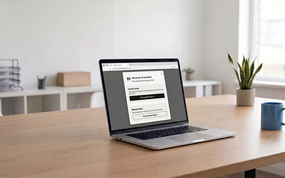 Open laptop on a wooden desk showing an AI assistant setup page in a bright office with plants and a mug