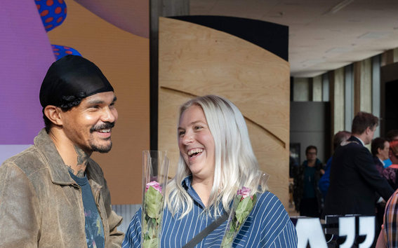 A man and a woman laughing. 