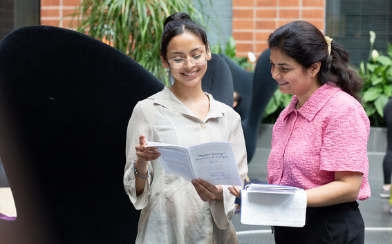 Professor and research disucssing an article.