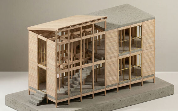 Scale model of a modern timber and concrete building with visible stairs and large framed windows.