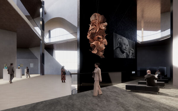 Modern interior with high ceilings, abstract sculpture, and people interacting or seated in a spacious lobby.