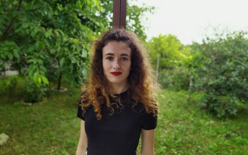 The portrait photo amid a green natural background