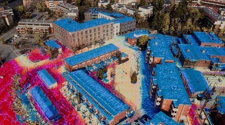 Oblique image of block-scale city model in game engine with overlaid watershed analysis visualization.