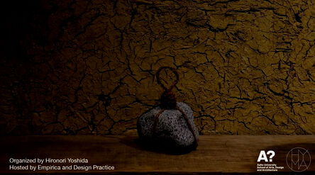 Poster for Kyoto craft workshop; cracked brown wall, grey stone tied with rope on a wooden surface