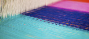 ARTS studio with a close-up on colourful yarns on a loom, image by Mikko Raskinen