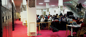 Photo from the K-floor of the Harald Herlin Learning Centre, students working at desks.