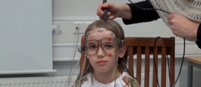 Magnetoencephalography (MEG) was used to study reading difficulties in children. This photo shows preparations for the measurement test. The child in the photo was not part of the study. Picture : Aalto University.