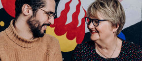 Two people talking and smiling