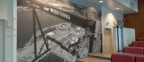 A picture of the Meyer shipyard on the wall of a company-sponsored lecture hall.