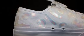 A white sneaker with glitter in the surface