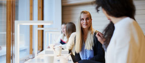 People drinking coffee in front of a desk