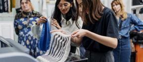 students at the printing workshop holding fabrics with fresh prints