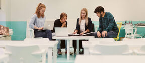 Four people gathered around a table