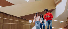 Aalto students walking down the stairs of Aalto University School of Business.