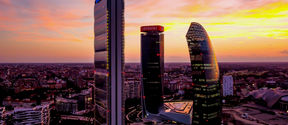 The CityLife skyscrapers in Milan depicted in a colorful sunset.