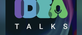 'Idea Talks' -logo ja sana 'unite!' alhaalla, tumma tausta ja värikkäät pyörteet.