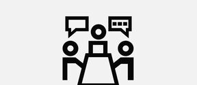 Icon of three people with speech bubbles around a table, indicating a meeting or discussion.