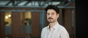 Sebastian Szyller photographed indoors on campus.