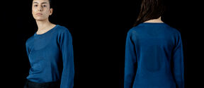 Two views of a person wearing a blue long-sleeved shirt and black trousers against a dark background.