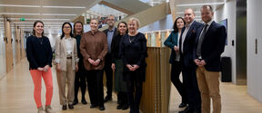School of Business Alumni Advisory Board 2026 members pictured at the School of Business, in front of the staircase