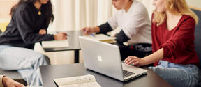 Students sitting at a table working.