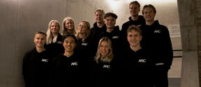 Members of the Aalto Running Club standing on stairs.