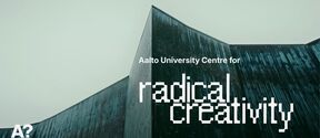 Angular teal building under grey sky with text: Aalto University Centre for radical creativity
