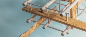 Abstract structure of pale rods and rough wooden planks against a light blue background