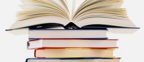 An open book standing on a tall stack of colourful closed books on a white background