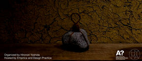 Poster for Kyoto craft workshop with cracked brown earth wall and tied grey stone on wooden table