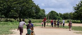 Entrance to Boman special education class, yard and pupils walking to outdoor lesson, plus Marikebun class by blocks