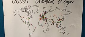 White poster reading “ISPA World Map” with an outlined world map covered in small coloured stickers