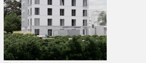 Modern five-storey white building surrounded by green trees and a cloudy sky.