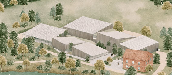 Aerial view of modern wooden buildings and a brick house, surrounded by trees and located near a river.