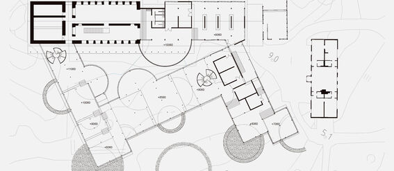 Architectural floor plan of a proposed kindergarten design, featuring interconnected sections and various outdoor spaces.