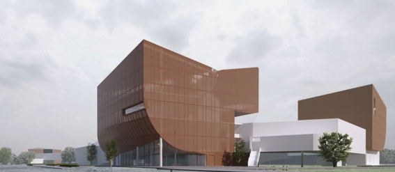 Modern building complex with large brown and white structures, surrounded by trees and a grey sky.