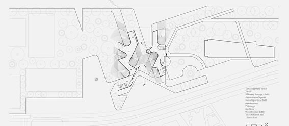 Architectural floor plan of a complex building layout with labelled sections including library, cafe, lounges, and exhibition hall.