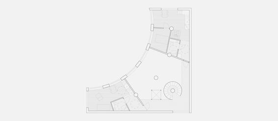 Architectural floor plan of the first floor, featuring curved walls, rooms, furniture, and a spiral staircase.